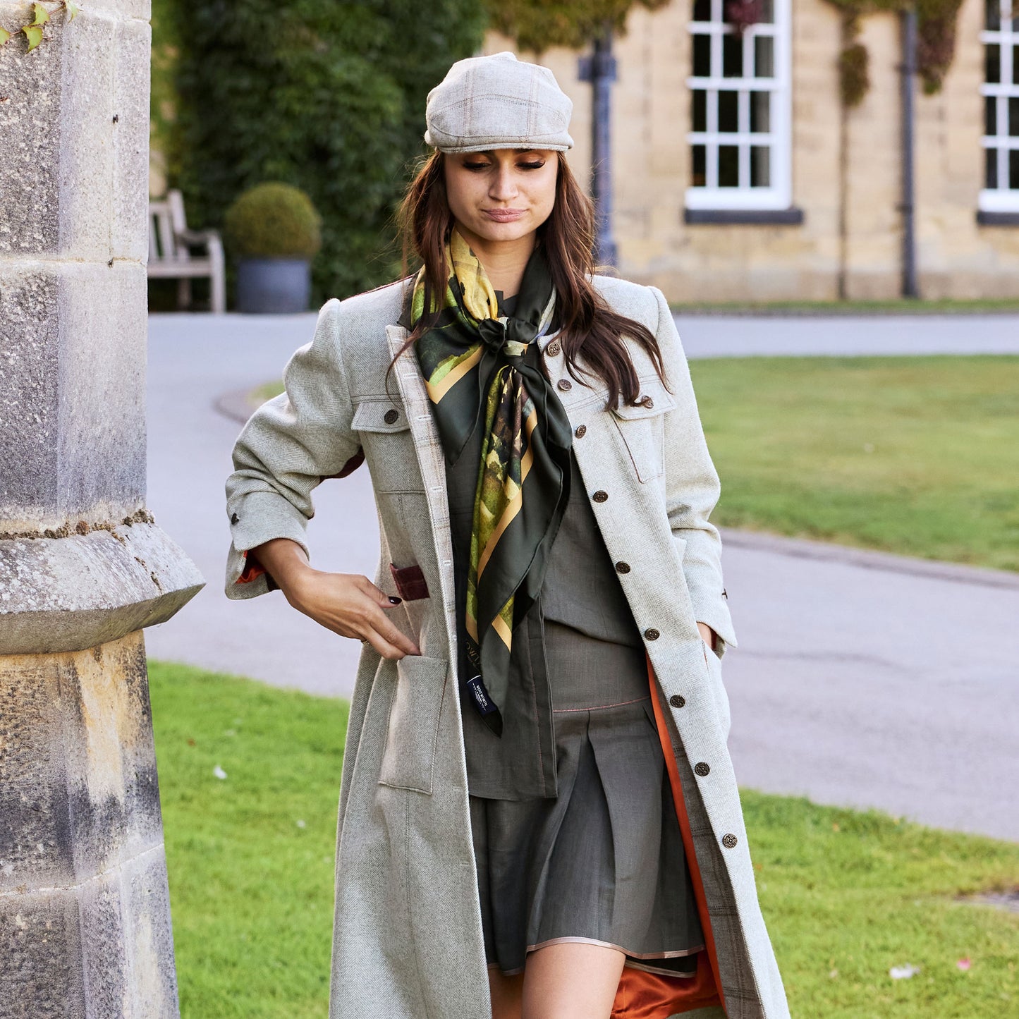 Lady in tweed coat and cap walking with By the Castle Gate silk scarf tied around her neck | Silk Scarf | Wentworth of Yorkshire