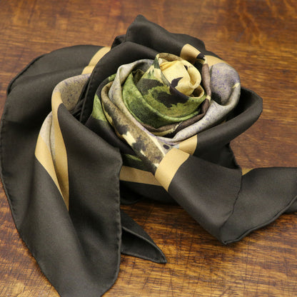 By the Castle Gate silk scarf folded as a rose on wooden table | Silk Scarf | Wentworth of Yorkshire.