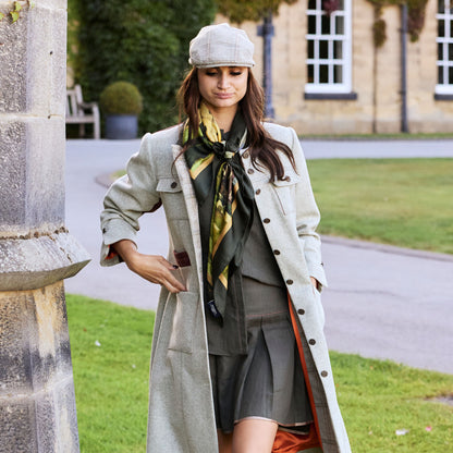 Lady in tweed coat and cap walking with By the Castle Gate silk scarf tied around her neck | Silk Scarf | Wentworth of Yorkshire
