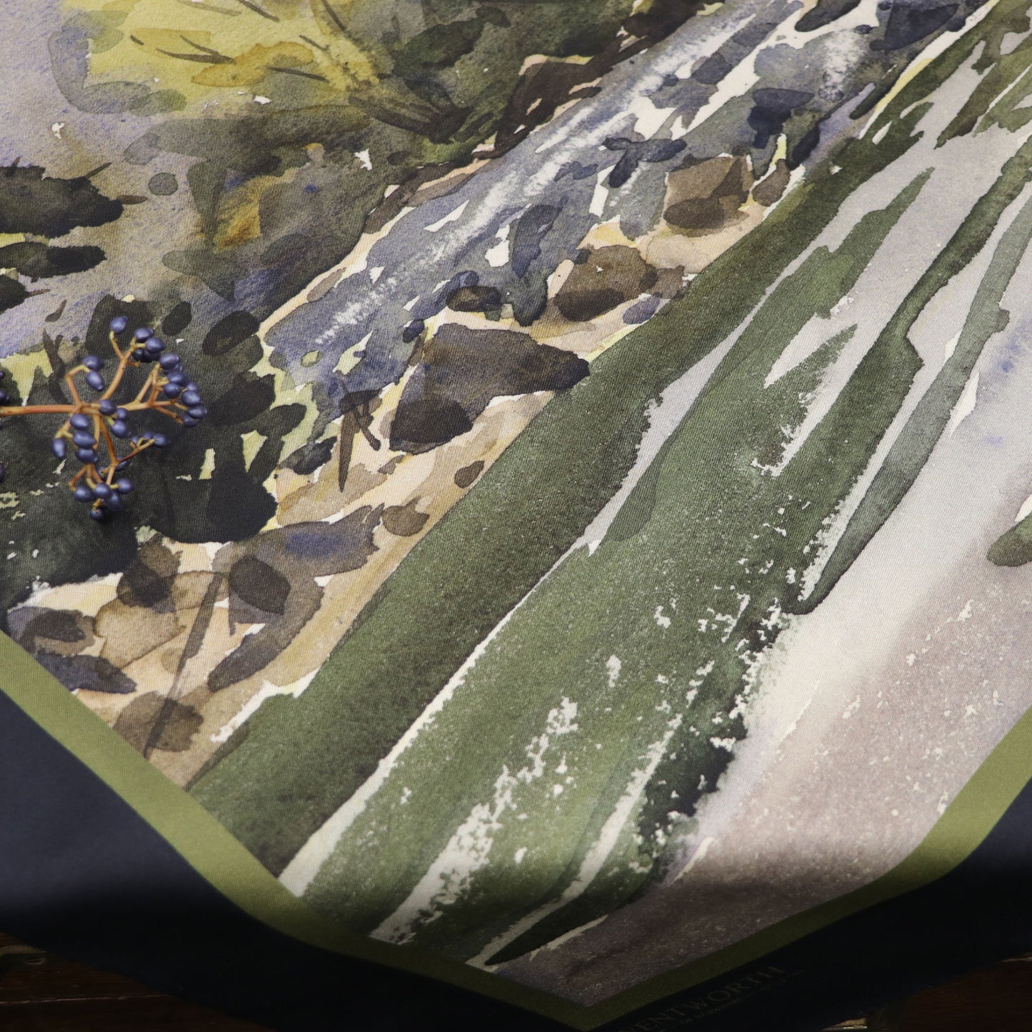 Where the Salmon Leap silk scarf laid on table with foliage