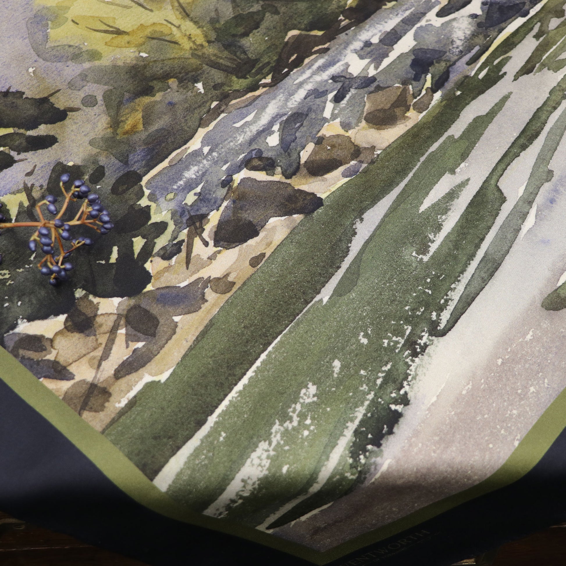 Where the Salmon Leap silk scarf laid on table with foliage