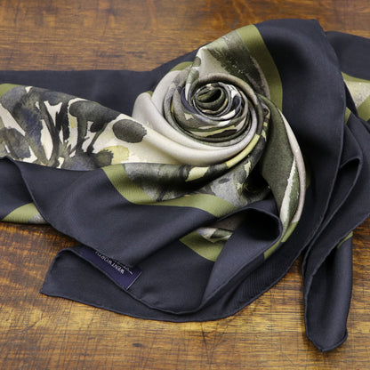Where the Salmon Leap silk scarf folded into a rose shown on wooden table | Silk Scarf | Wentworth of Yorkshire
