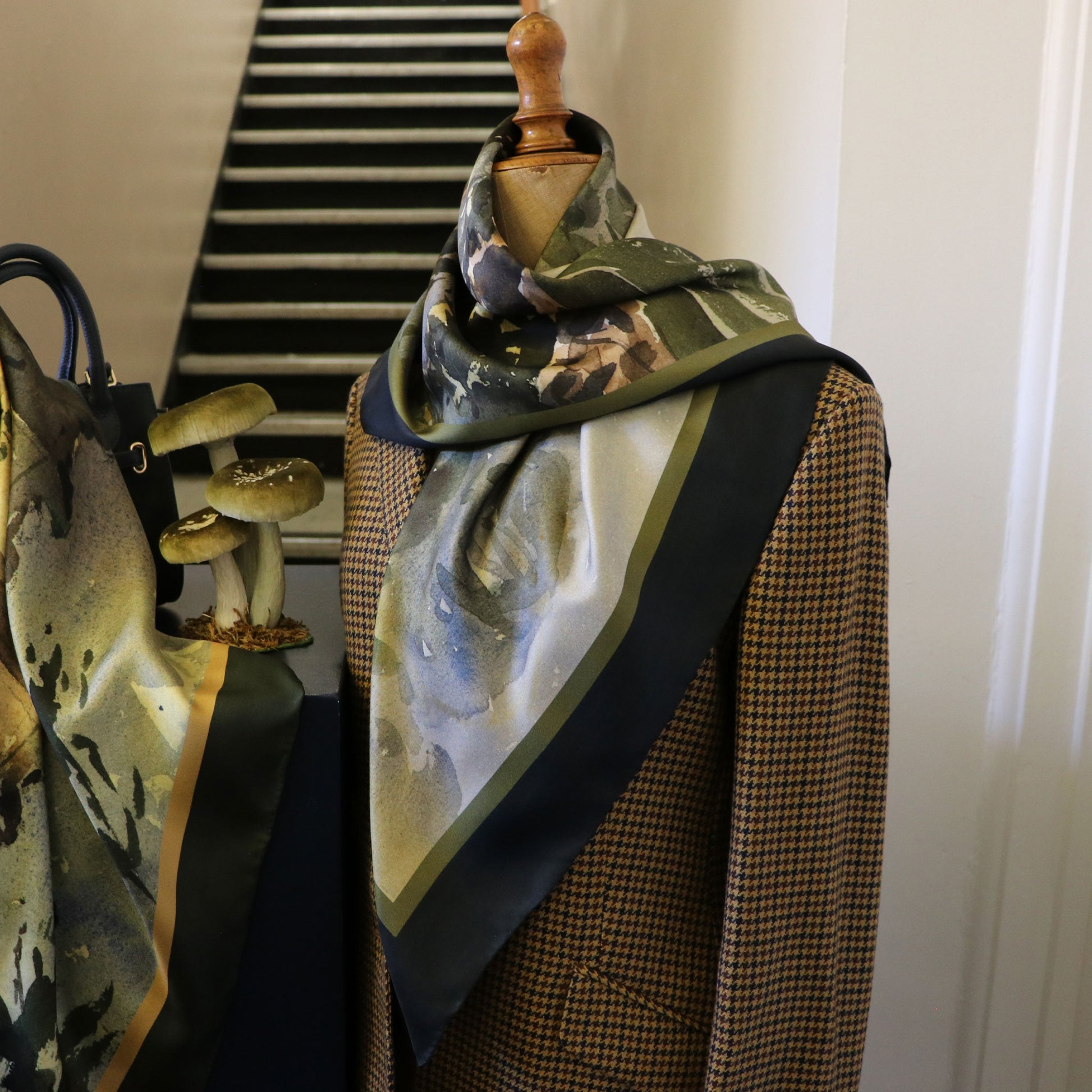 Mannequin wearing tweed jacket with Where the Salmon Leap silk scarf draped around neck | Silk Scarf | Wentworth of Yorkshire