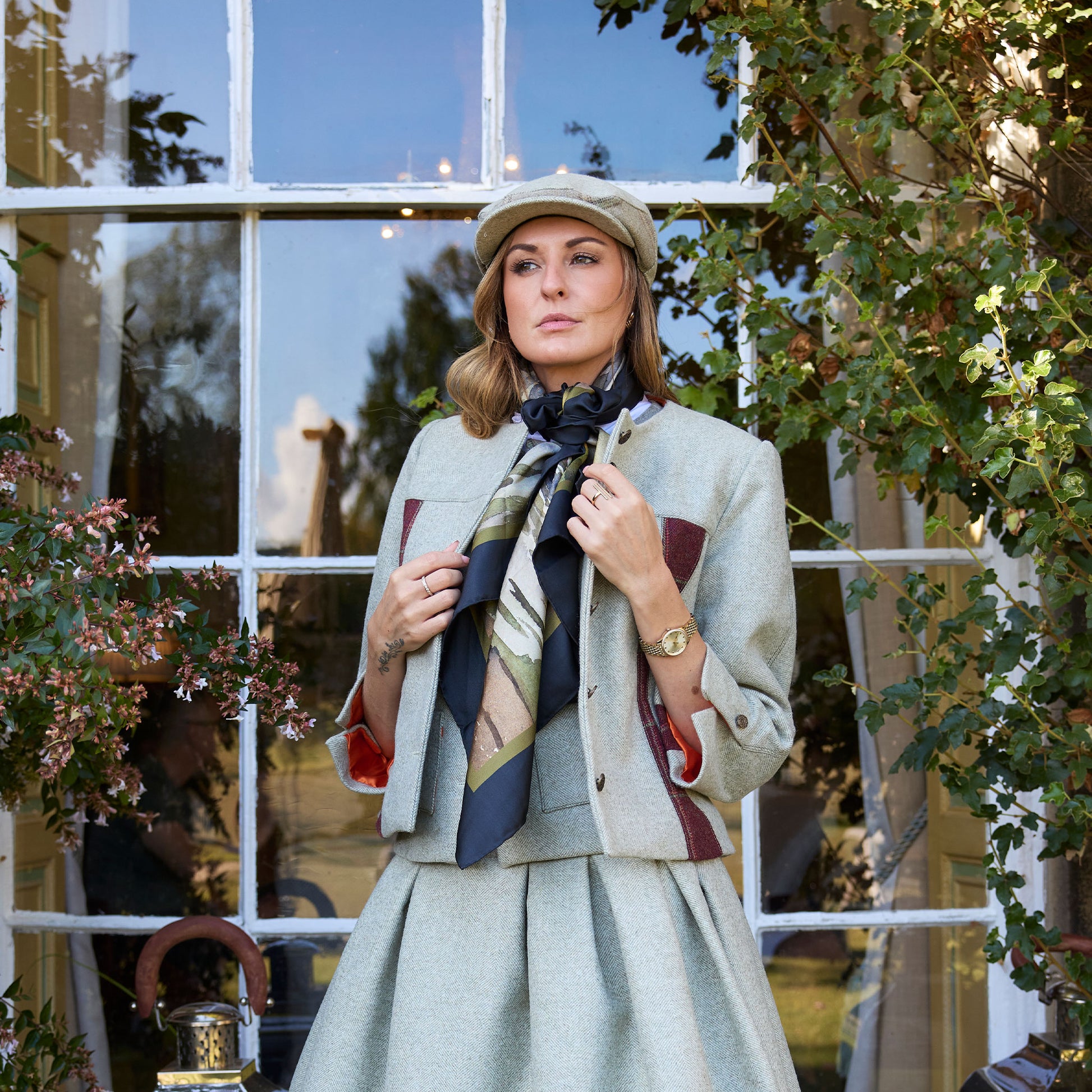 Lady wearing tweed suit and cap with Where the Salmon Leap silk scarf tied around next | Silk Scarf | Wentworth of Yorkshire